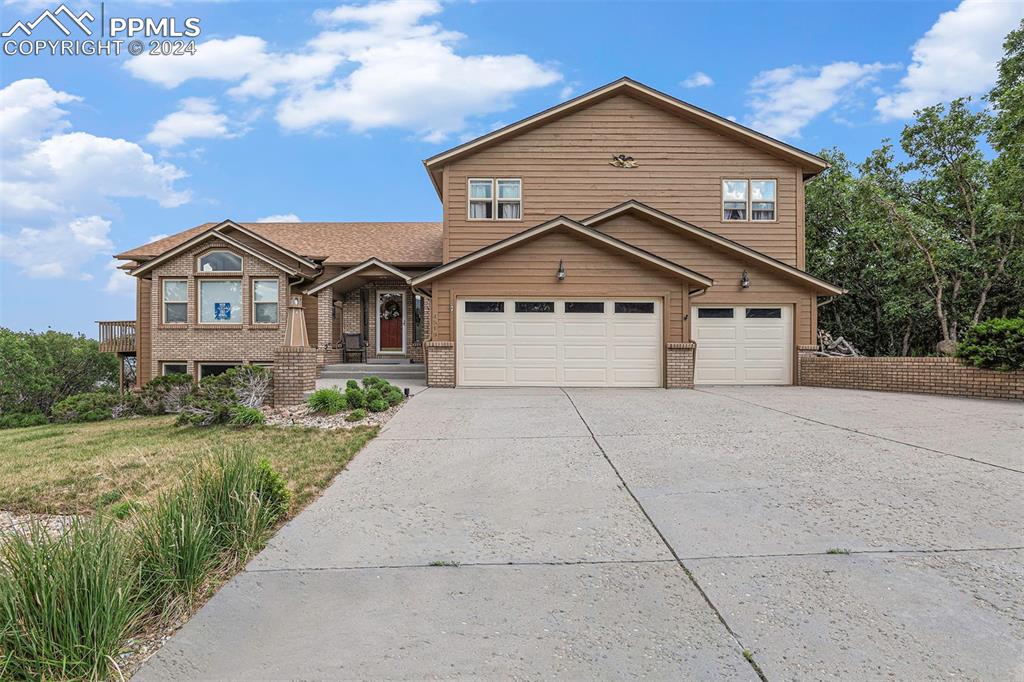 4315 Star Ranch Road Colorado Springs, CO 80906 - Photo 38 of 47 a front view of a house with a yard and garage