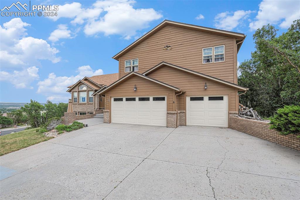 4315 Star Ranch Road Colorado Springs, CO 80906 - Photo 39 of 47 a view of a house with a yard and garage
