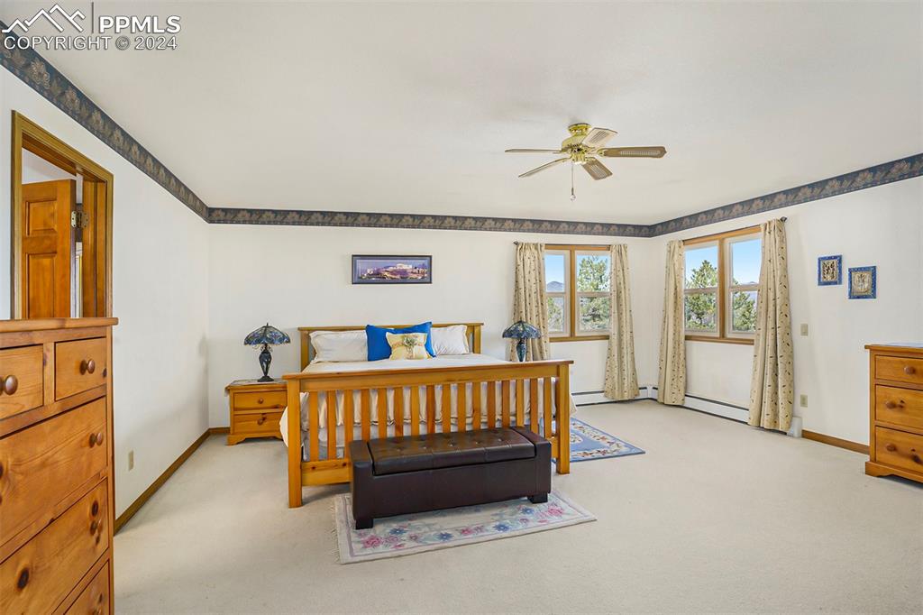 4315 Star Ranch Road Colorado Springs, CO 80906 - Photo 6 of 47 a bedroom with furniture and a chandelier fan