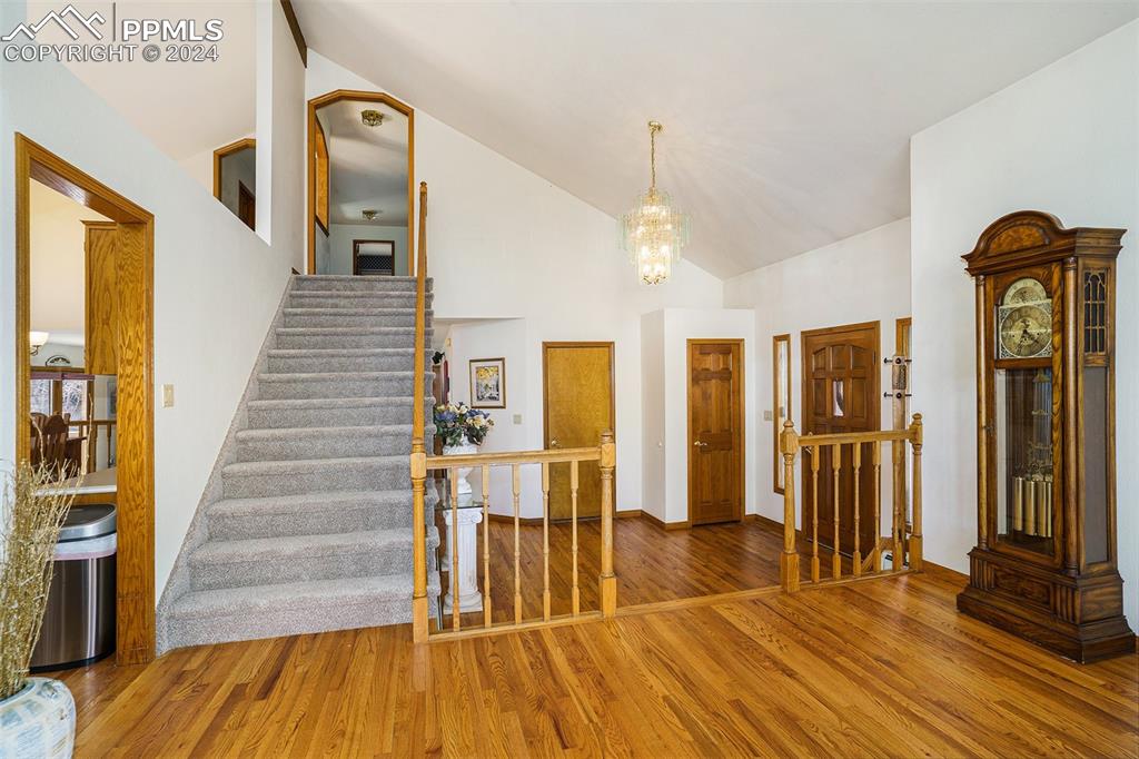 4315 Star Ranch Road Colorado Springs, CO 80906 - Photo 8 of 47 a view of a livingroom with wooden floor and stairs