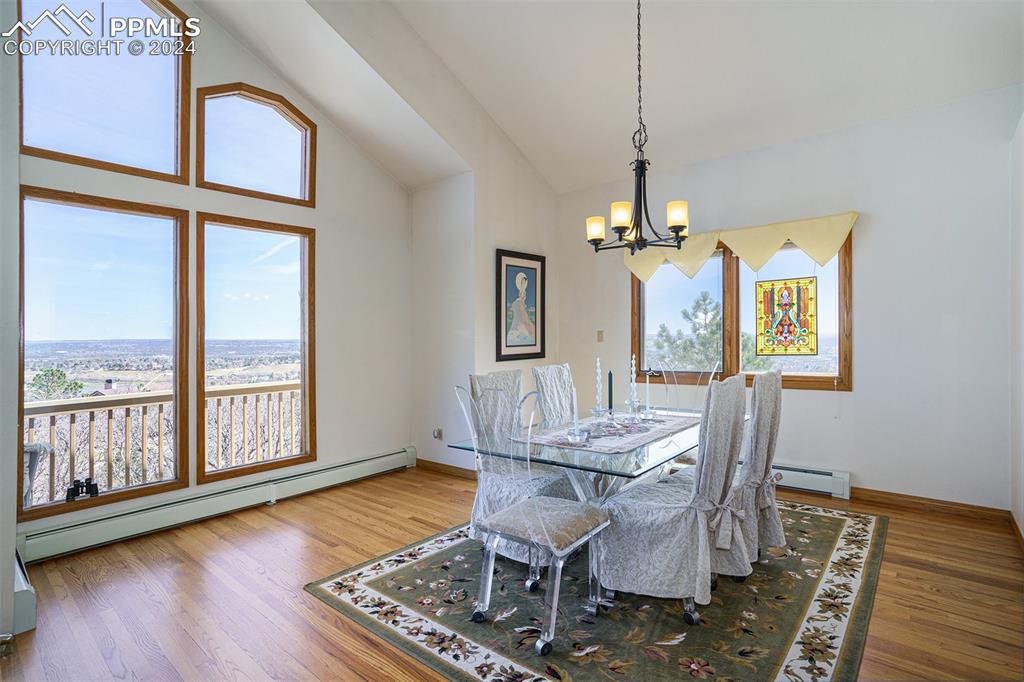 4315 Star Ranch Road Colorado Springs, CO 80906 - Photo 10 of 47 a view of a dining room with furniture window and wooden floor