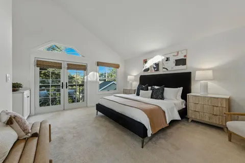 a spacious bedroom with a bed and a window