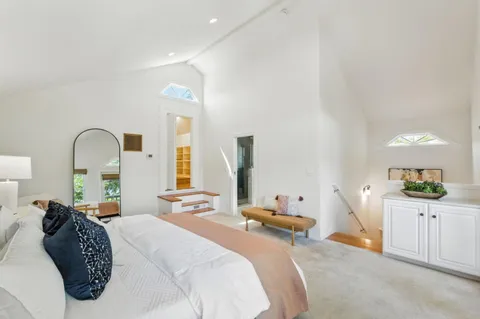 a bedroom with bed and window