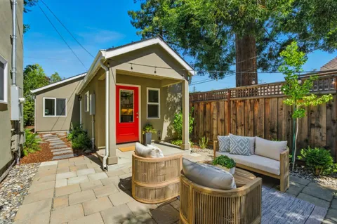 a view of outdoor sitting area with furniture and wooden fence
