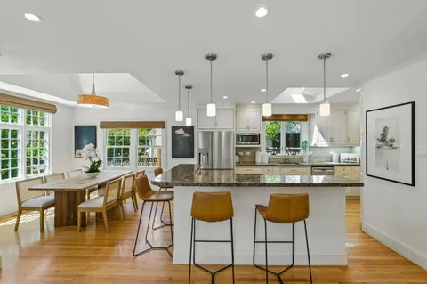 a large kitchen with a table and chairs