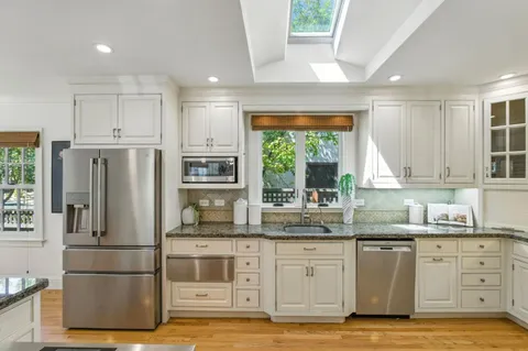 a kitchen with stainless steel appliances granite countertop a refrigerator sink and cabinets