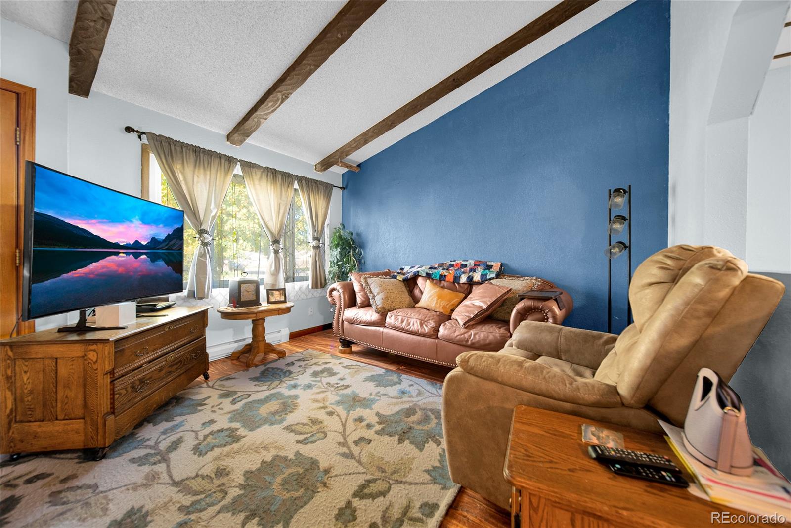 404 Hickory Street Fort Morgan, CO 80701 - Photo 11 of 37 a living room with furniture and a flat screen tv