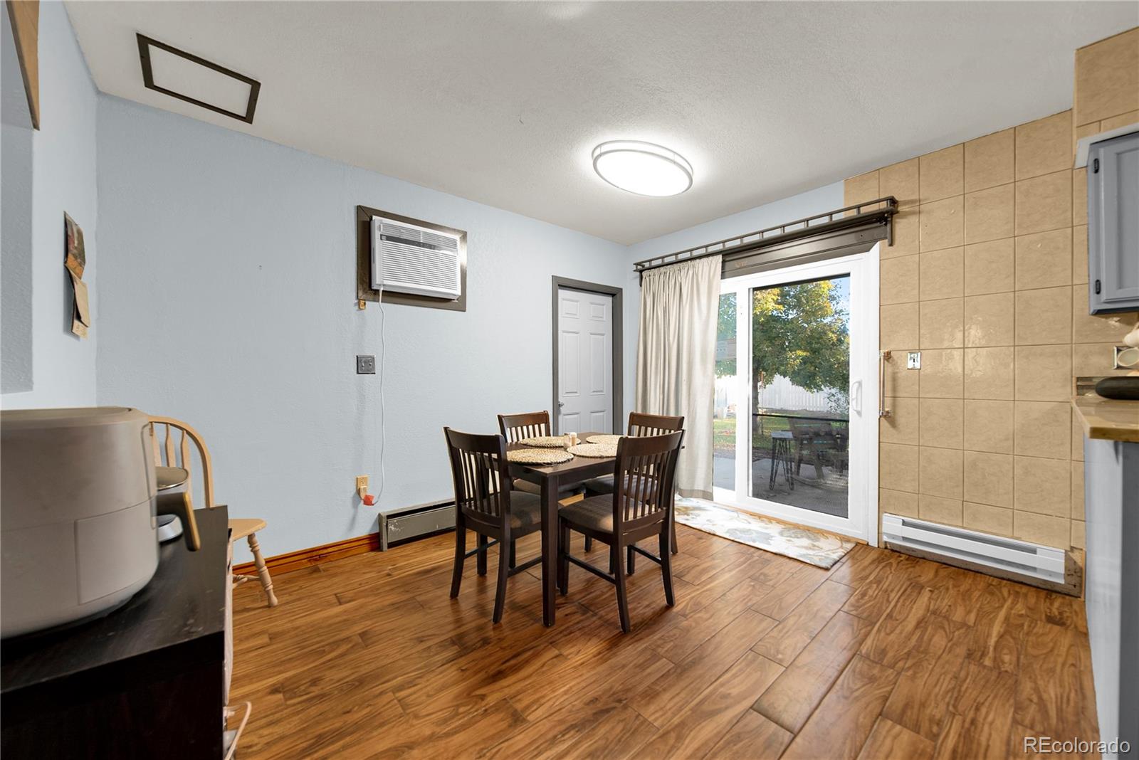 404 Hickory Street Fort Morgan, CO 80701 - Photo 15 of 37 a dining room with furniture and wooden floor