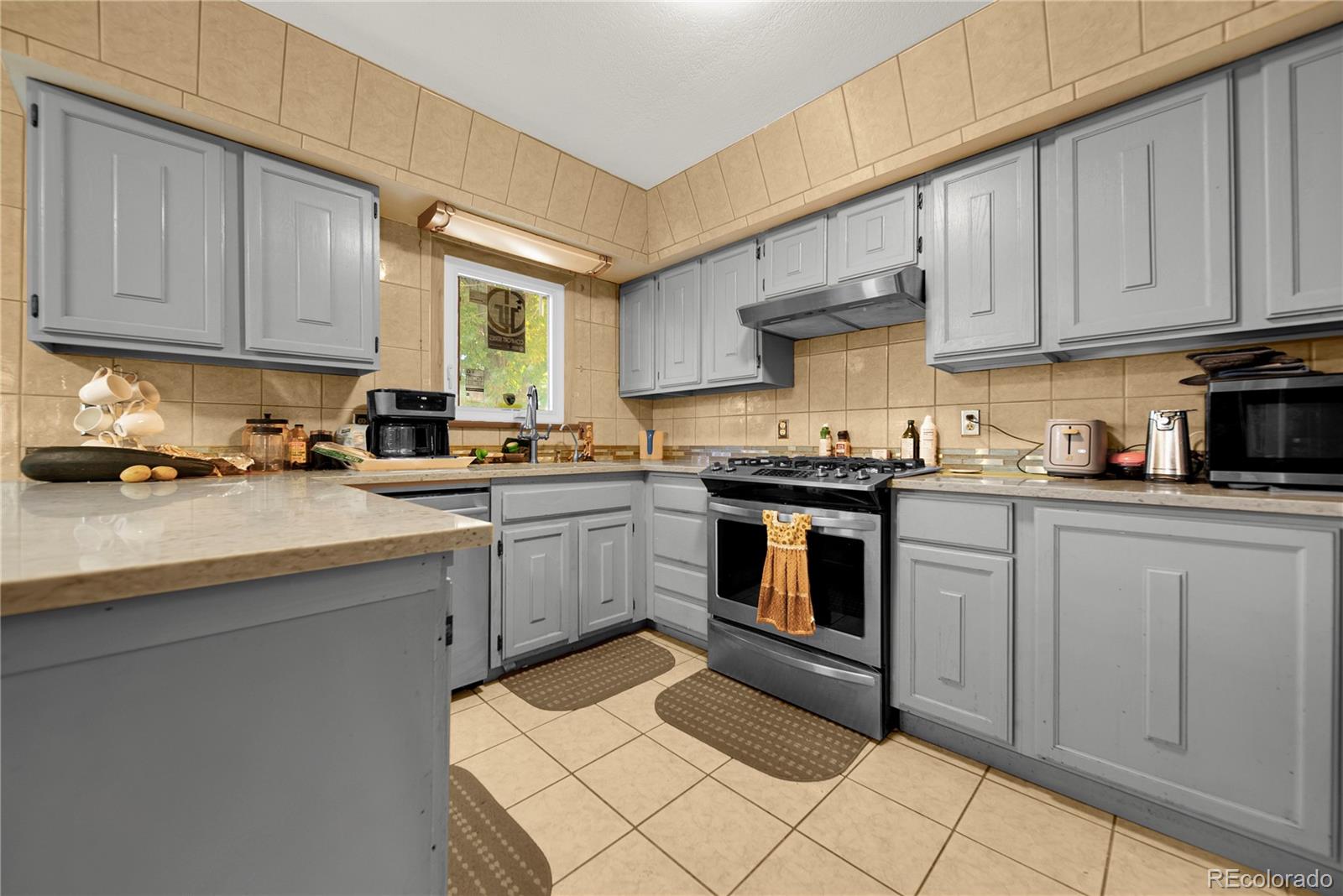 404 Hickory Street Fort Morgan, CO 80701 - Photo 17 of 37 a kitchen with granite countertop a sink stainless steel appliances and cabinets