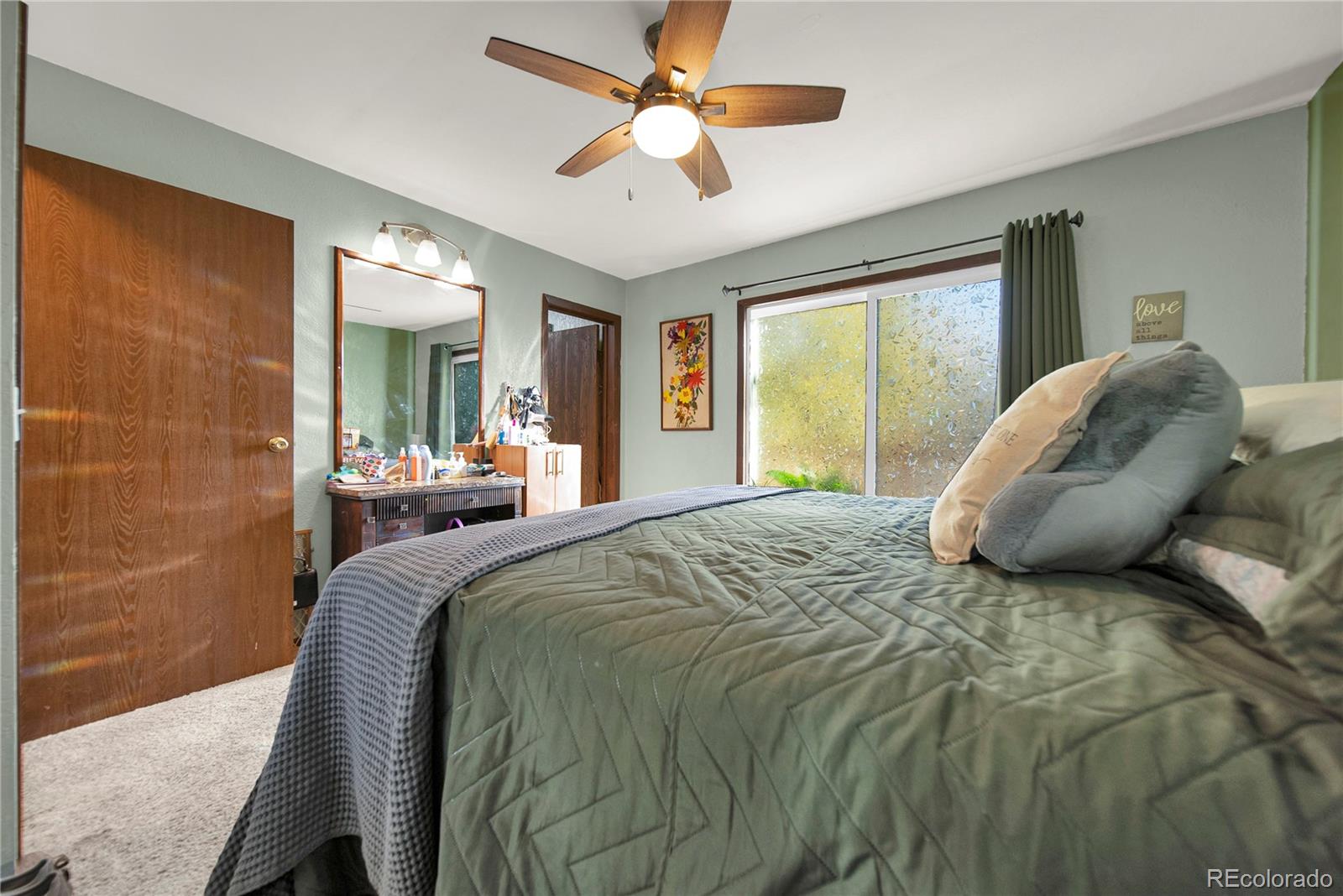 404 Hickory Street Fort Morgan, CO 80701 - Photo 21 of 37 a bed sitting in a bedroom next to a window