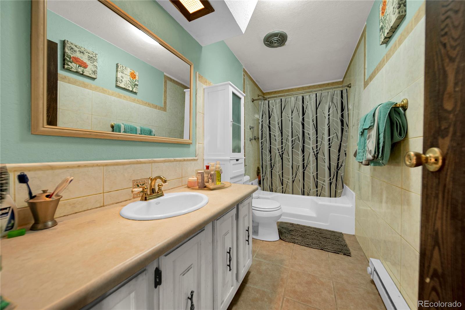 404 Hickory Street Fort Morgan, CO 80701 - Photo 22 of 37 a bathroom with a sink a toilet and shower