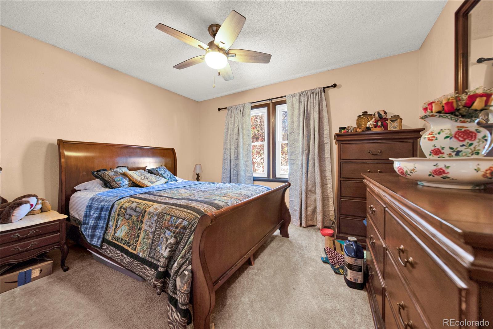 404 Hickory Street Fort Morgan, CO 80701 - Photo 23 of 37 a bedroom with a bed and a chandelier