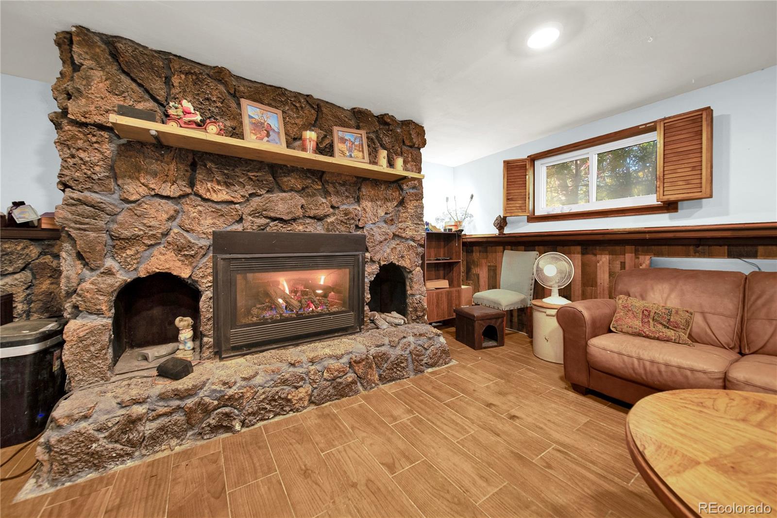 404 Hickory Street Fort Morgan, CO 80701 - Photo 26 of 37 a living room with furniture a fireplace and a large window