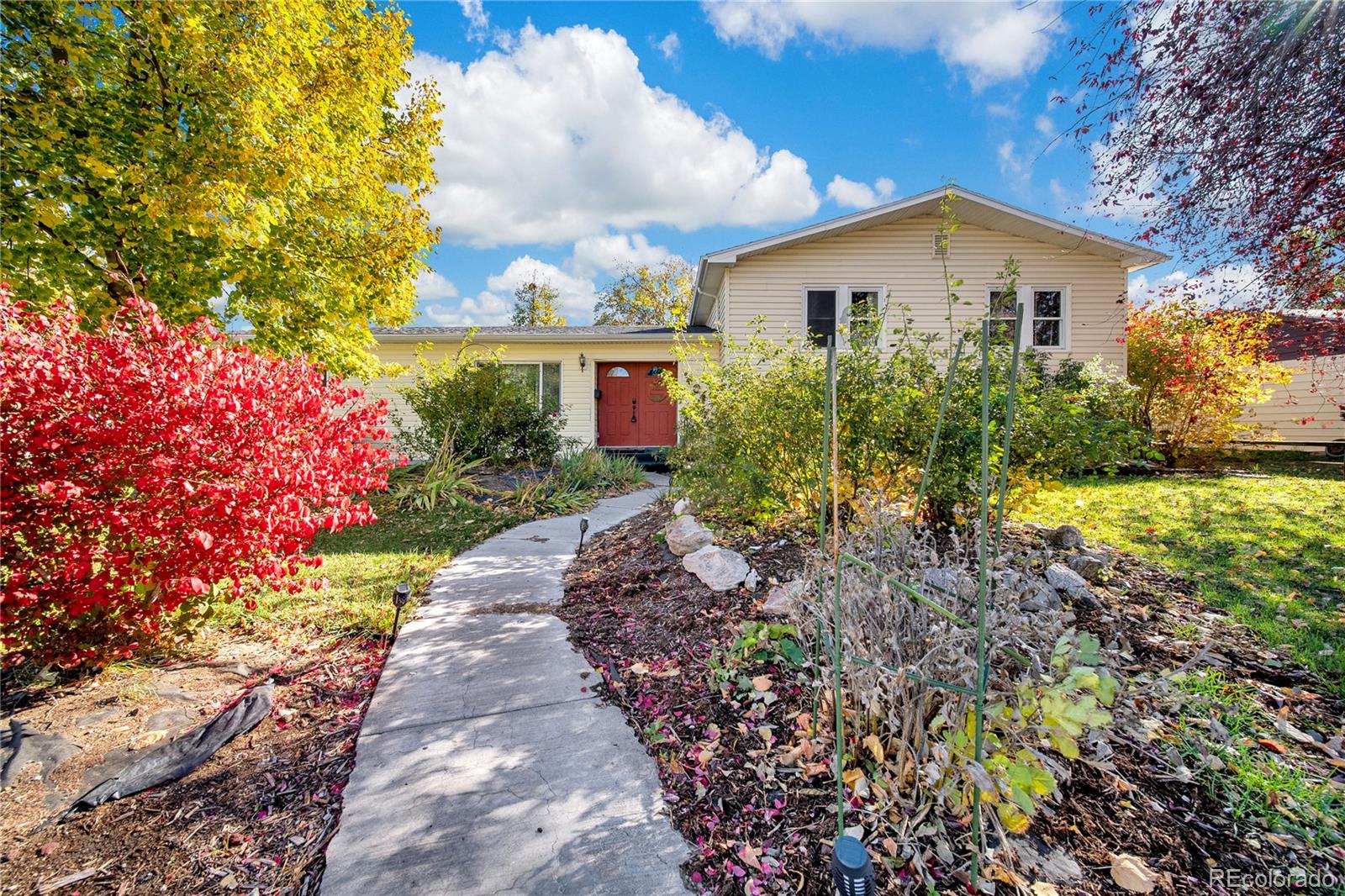 404 Hickory Street Fort Morgan, CO 80701 - Photo 3 of 37 a view of a house with a yard and garden