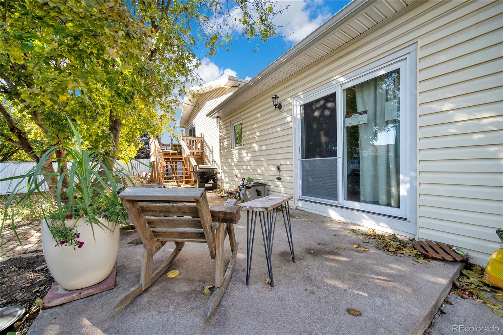 404 Hickory Street Fort Morgan, CO 80701 - Photo 32 of 37 a view of a patio with table and chairs and potted plants