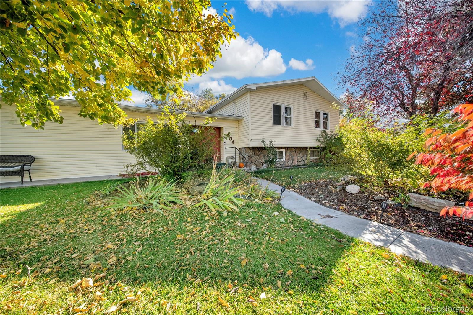404 Hickory Street Fort Morgan, CO 80701 - Photo 4 of 37 a backyard of a house with plants and large trees