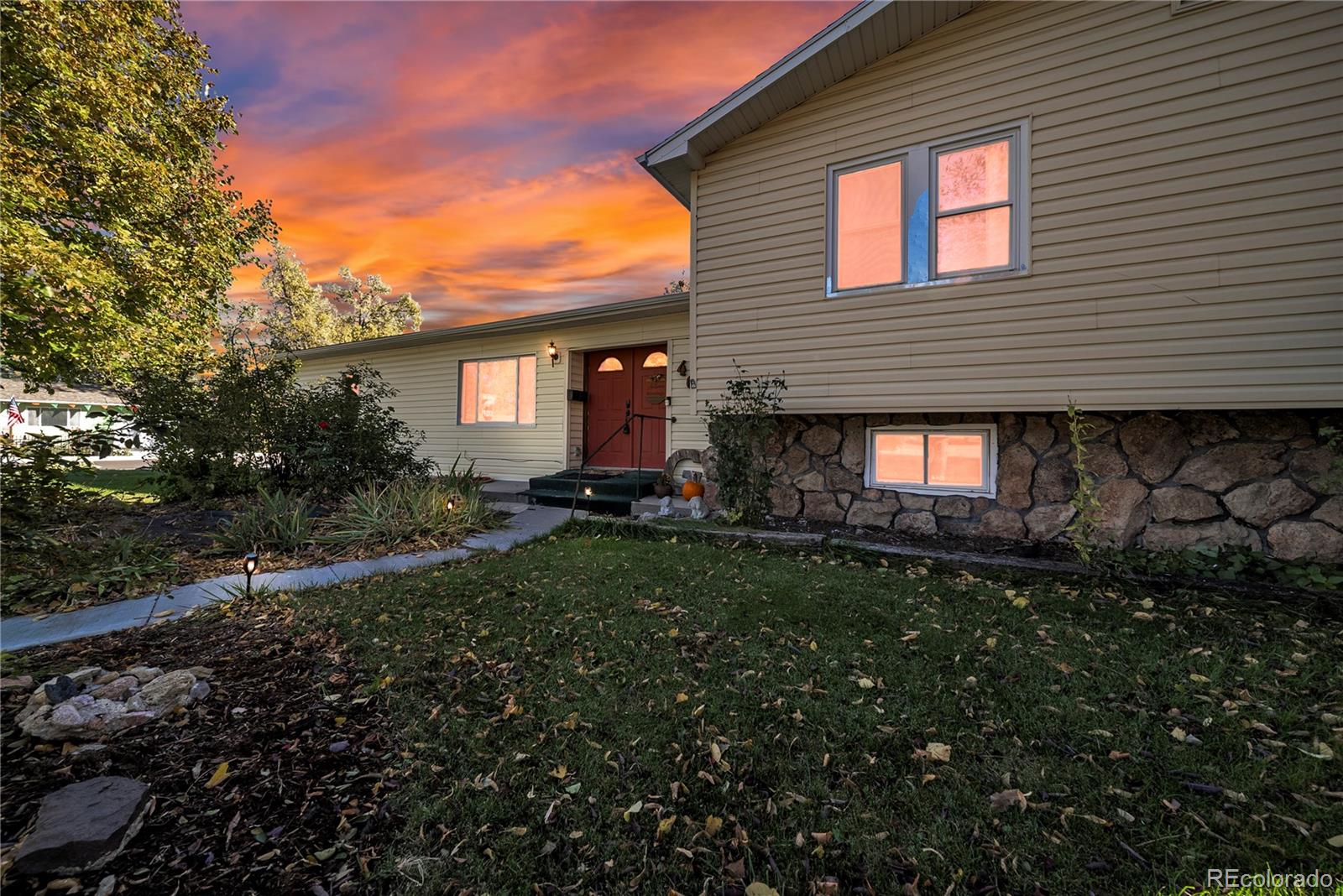 404 Hickory Street Fort Morgan, CO 80701 - Photo 6 of 37 a view of a backyard with plants and a large tree