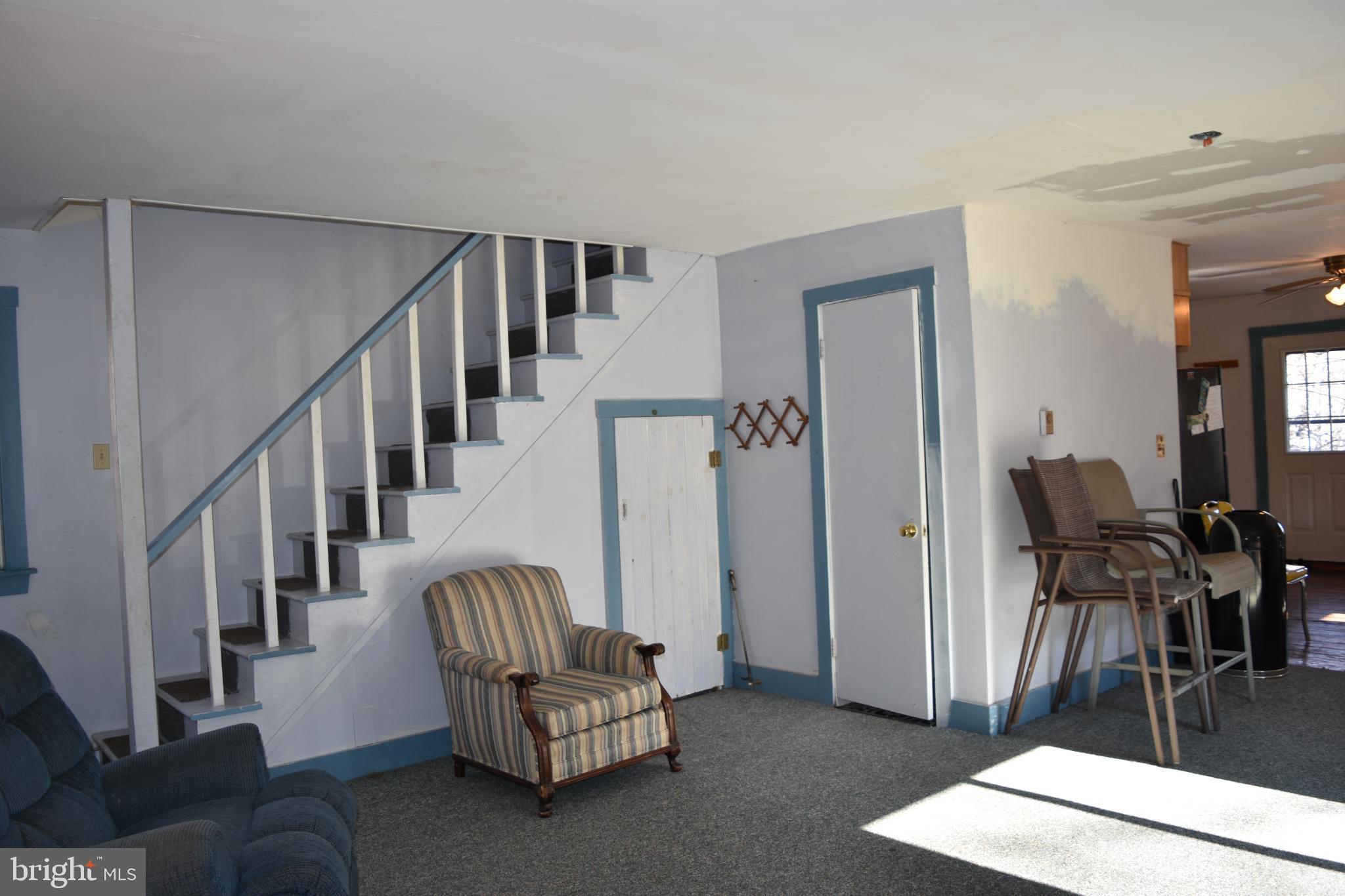 1417 Mountainside Road Berkeley Springs, WV 25411 - Photo 16 of 76 Spacious living area with charming staircase.