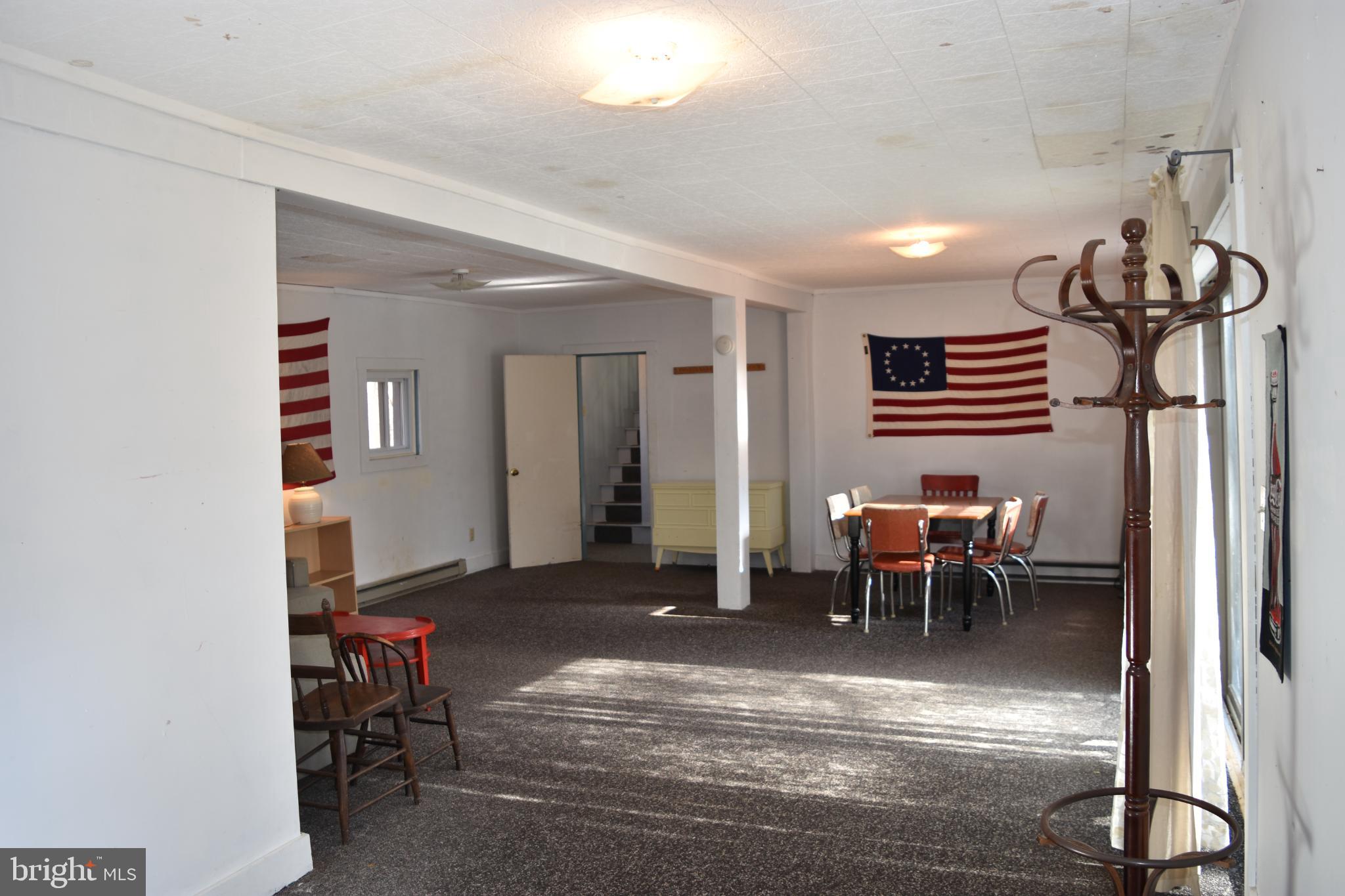 1417 Mountainside Road Berkeley Springs, WV 25411 - Photo 21 of 76 Spacious room adorned with historic flags.