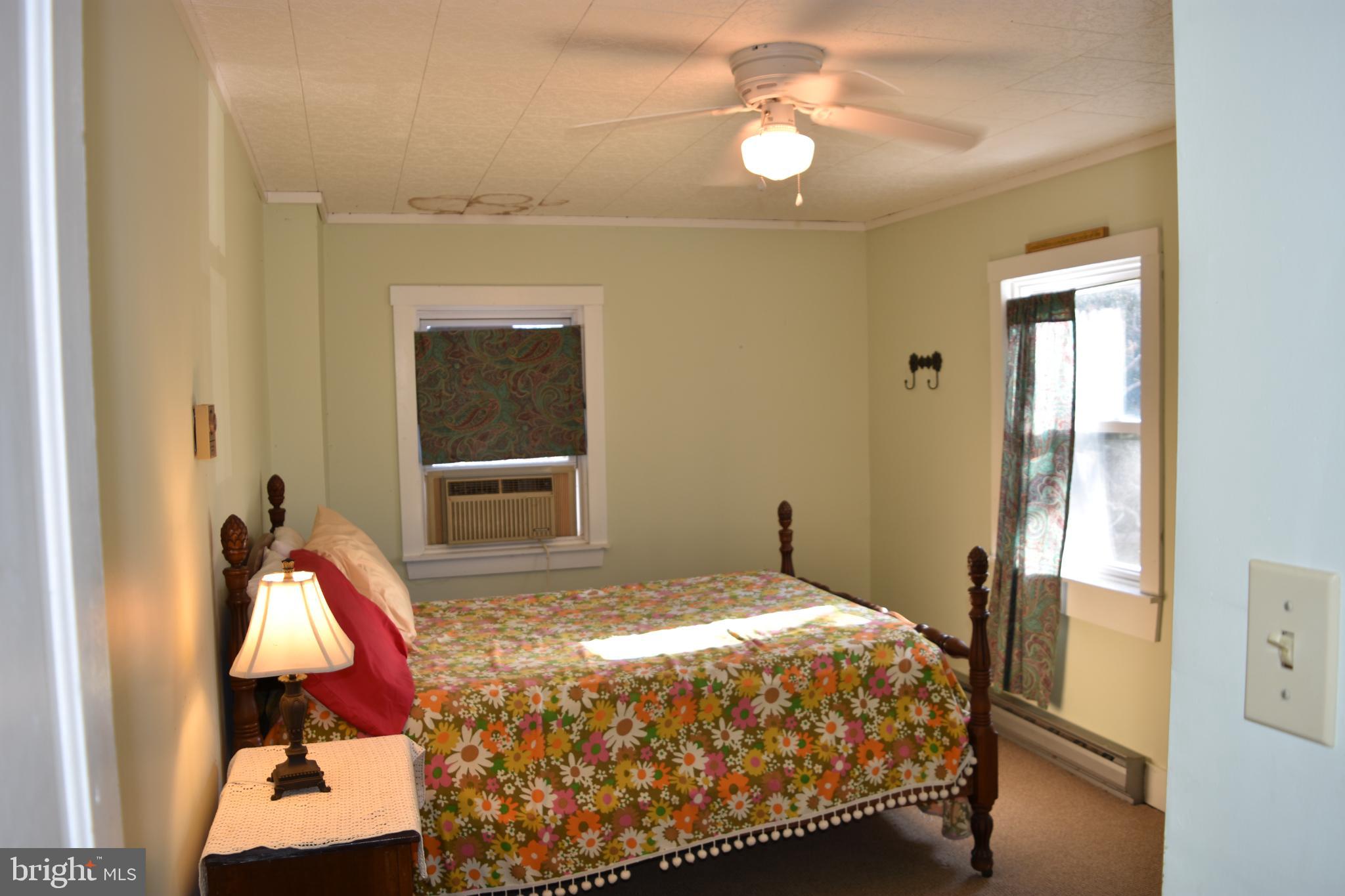 1417 Mountainside Road Berkeley Springs, WV 25411 - Photo 29 of 76 Cozy bedroom with floral accents and light.