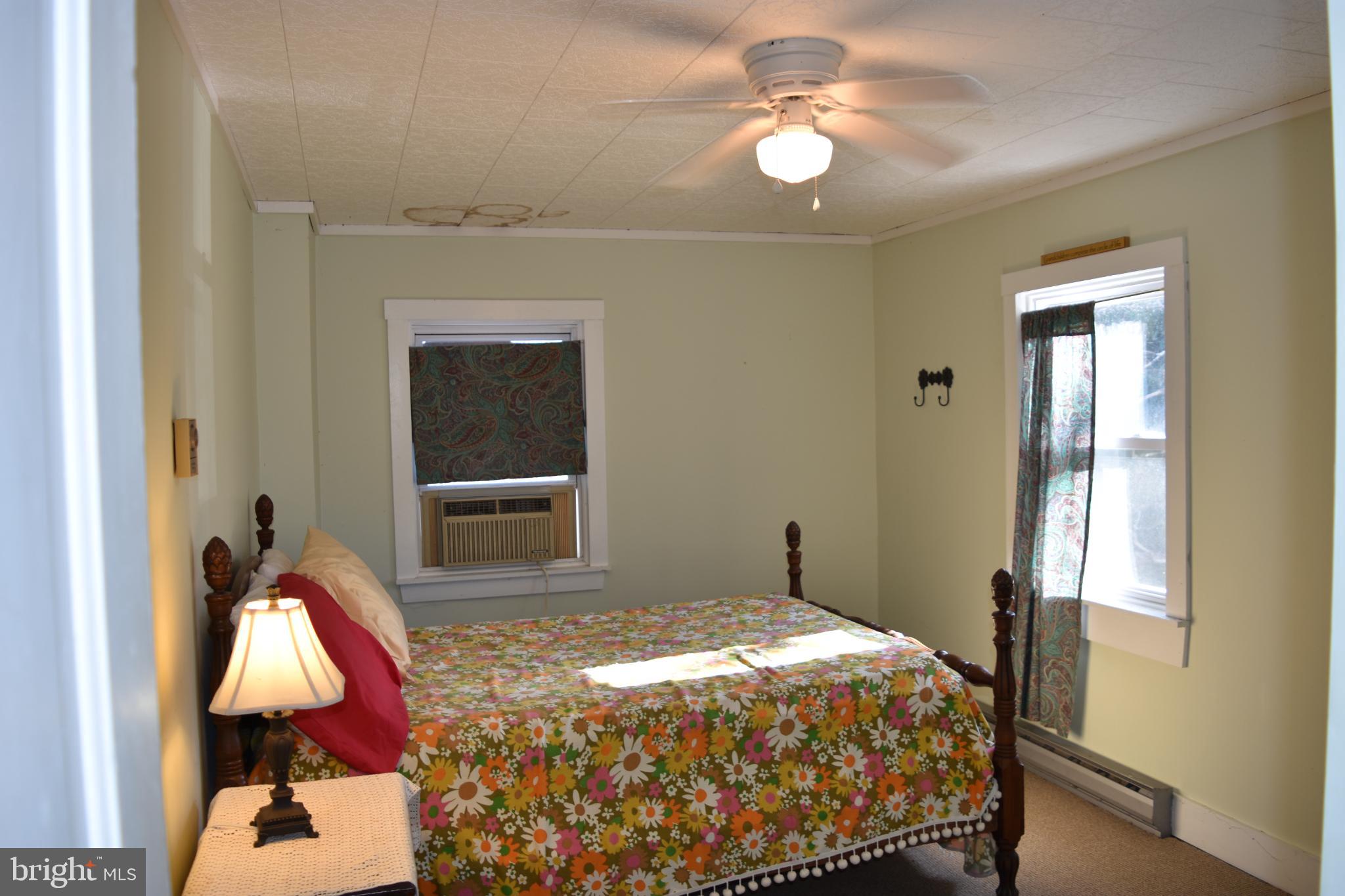1417 Mountainside Road Berkeley Springs, WV 25411 - Photo 32 of 76 Cozy bedroom with floral accents and light.