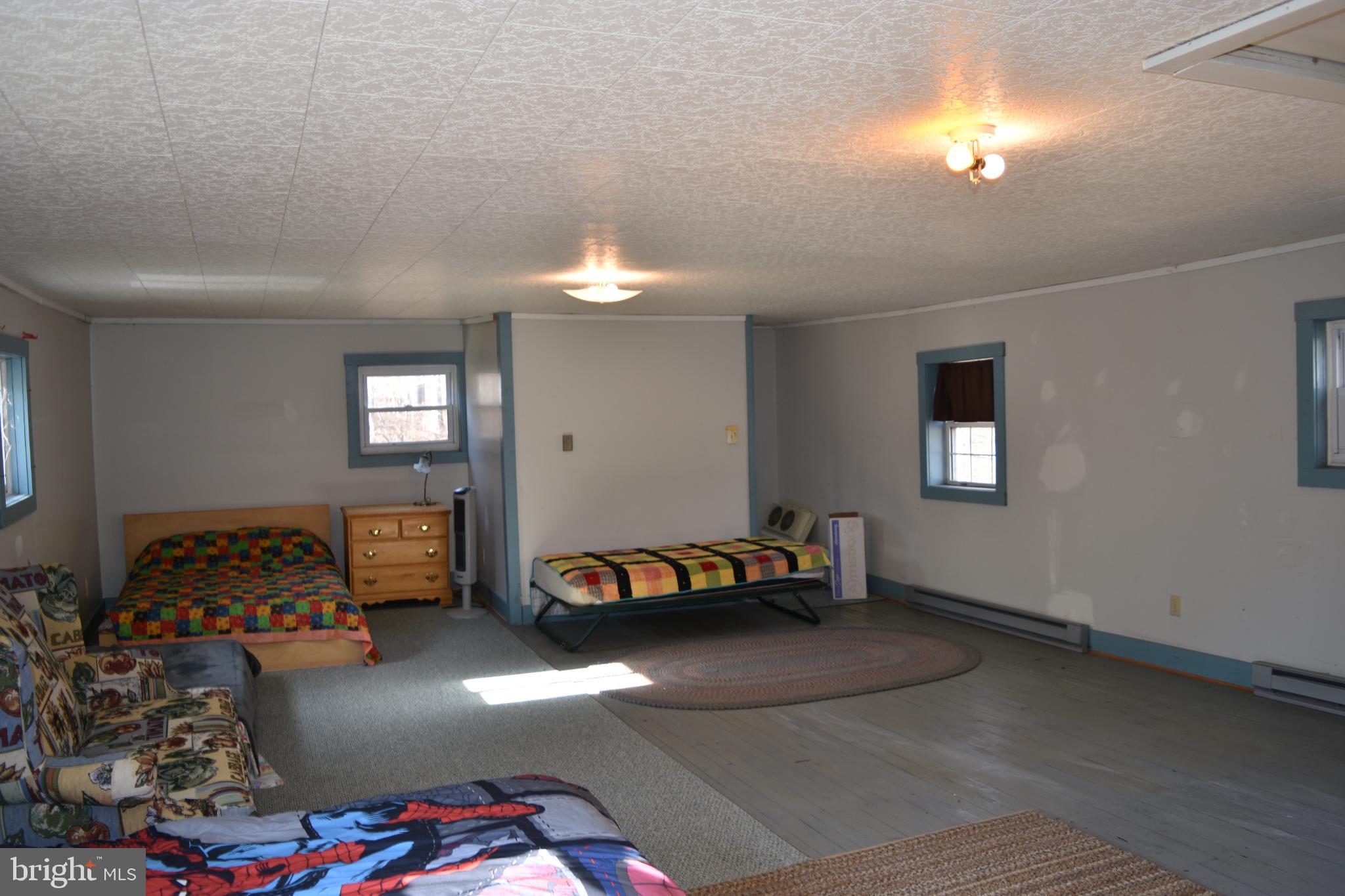1417 Mountainside Road Berkeley Springs, WV 25411 - Photo 33 of 76 Spacious room with natural light and charm.
