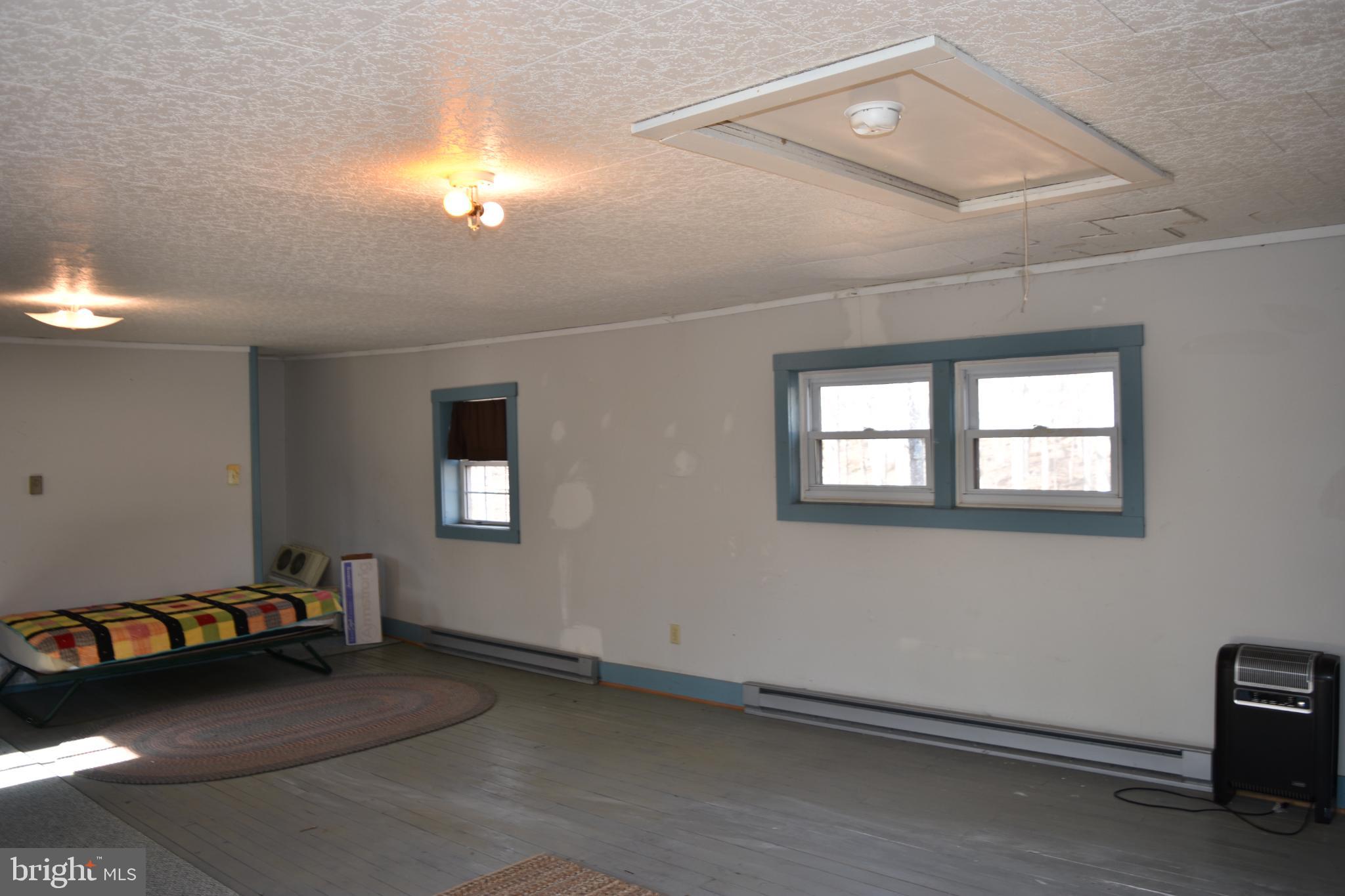 1417 Mountainside Road Berkeley Springs, WV 25411 - Photo 34 of 76 Spacious room with natural light and charm.