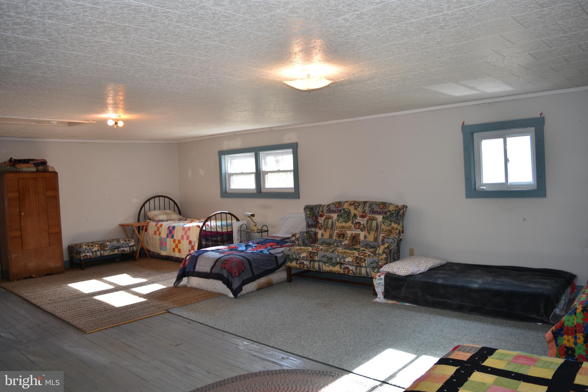1417 Mountainside Road Berkeley Springs, WV 25411 - Photo 37 of 76 Spacious, light-filled room with cozy beds.