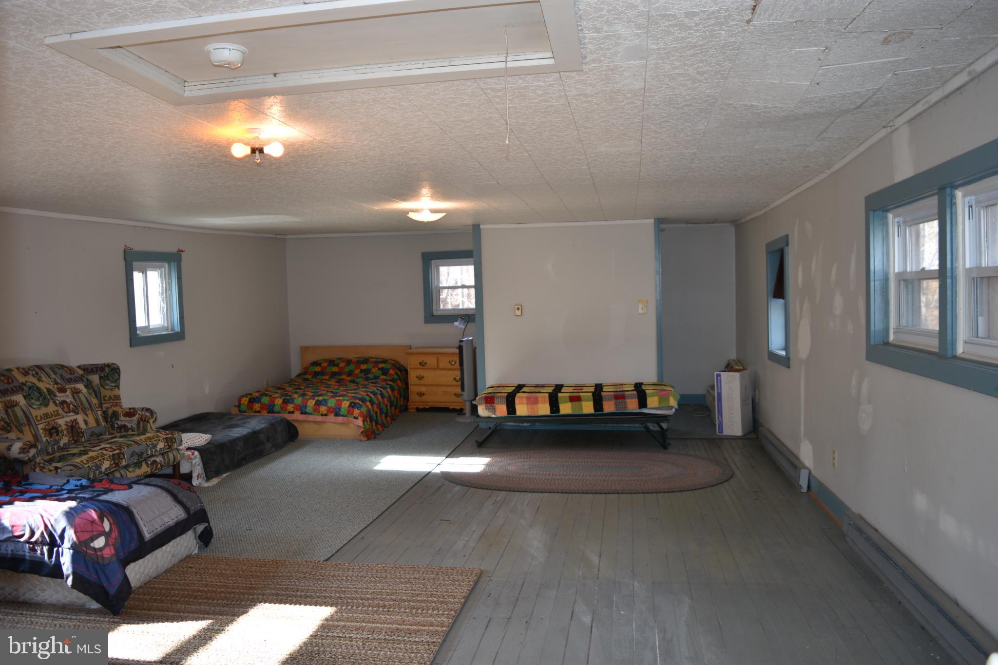 1417 Mountainside Road Berkeley Springs, WV 25411 - Photo 40 of 76 Spacious, sunlit room with cozy charm.