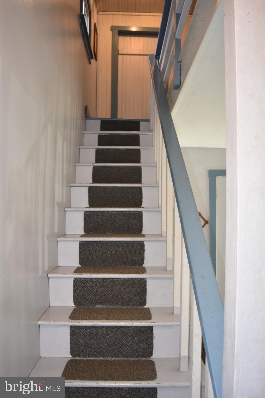 1417 Mountainside Road Berkeley Springs, WV 25411 - Photo 51 of 76 Inviting staircase leading to upper rooms.
