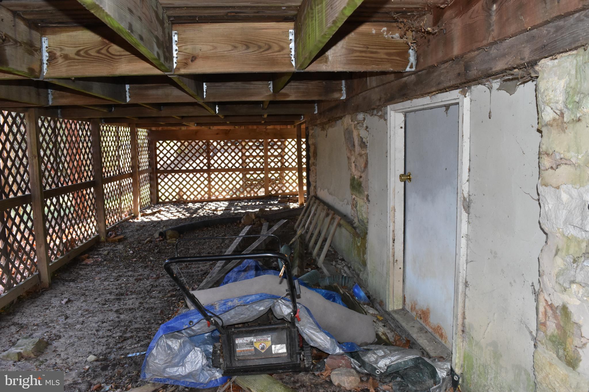 1417 Mountainside Road Berkeley Springs, WV 25411 - Photo 63 of 76 Under deck storage space and crawl space access