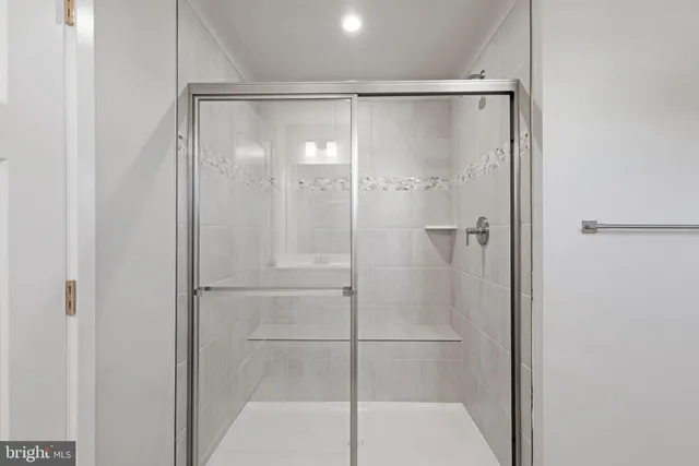 a bathroom with a granite countertop toilet and a sink