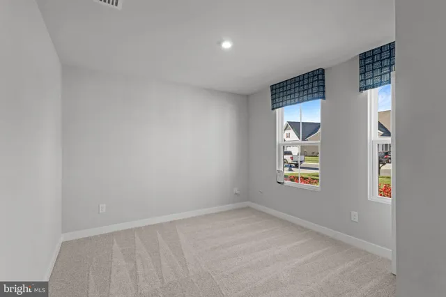 an empty room with windows and entryway