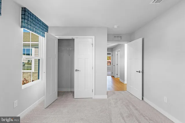 a bathroom with a sink a toilet and a large mirror