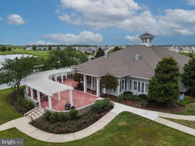 an aerial view of a house a yard and a lake view