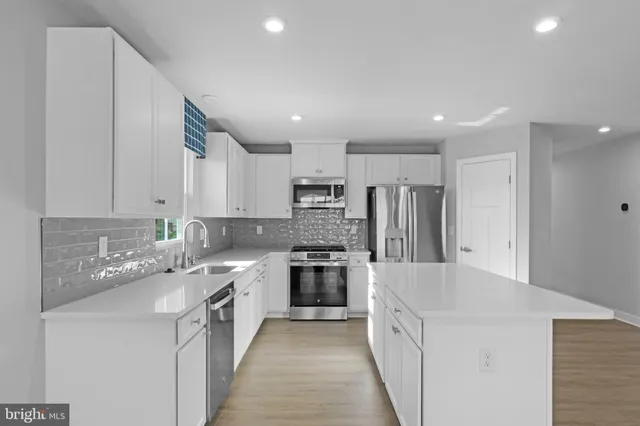 a large kitchen with a stove top oven
