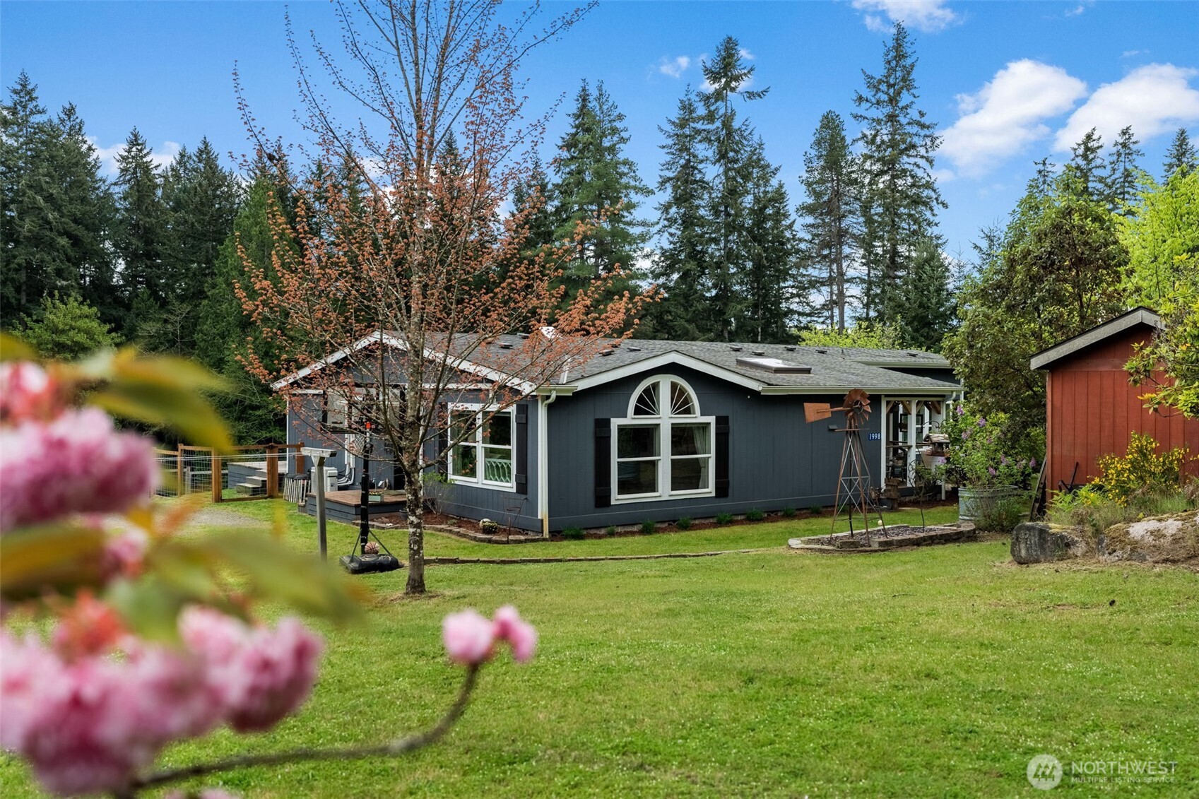 1998 Northwest Luoto Road Poulsbo, WA 98370 - Photo 2 of 40 a front view of a house with garden