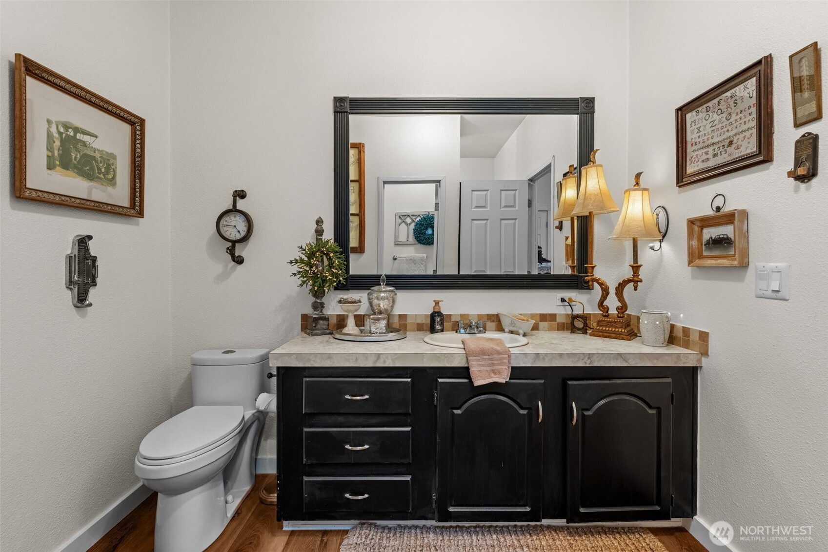1998 Northwest Luoto Road Poulsbo, WA 98370 - Photo 22 of 40 a bathroom with a toilet a sink and mirror