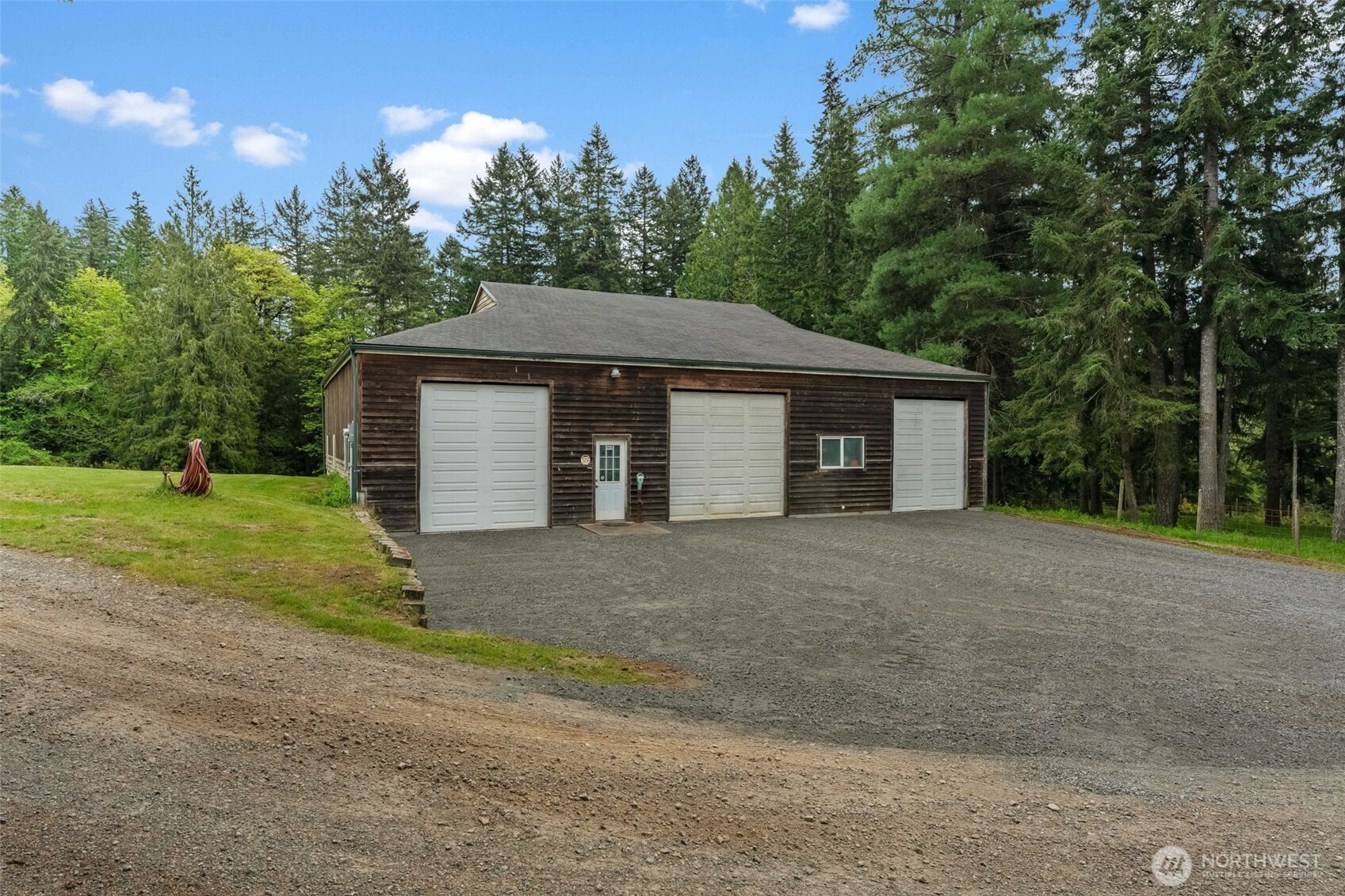 1998 Northwest Luoto Road Poulsbo, WA 98370 - Photo 33 of 40 a front view of a house with a yard and garage