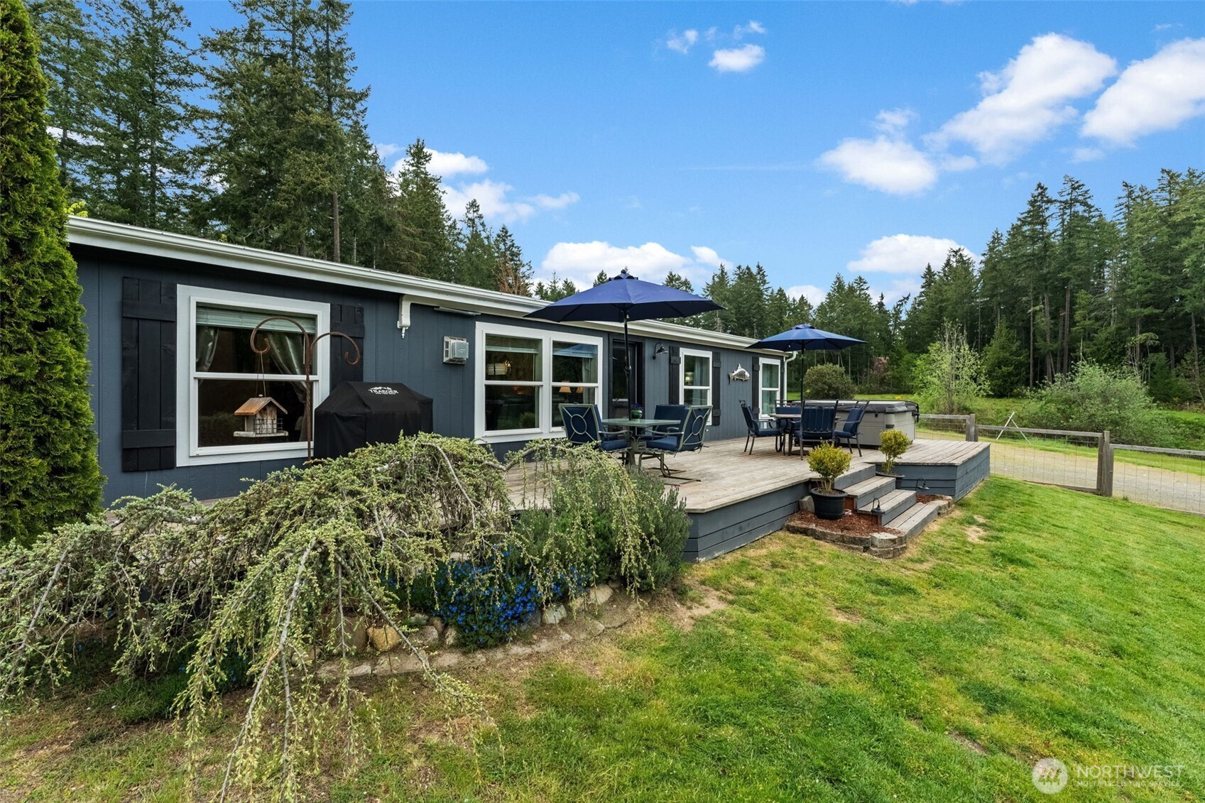 1998 Northwest Luoto Road Poulsbo, WA 98370 - Photo 38 of 40 a view of a house with patio and a garden