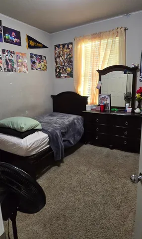 a bedroom with a bed and window