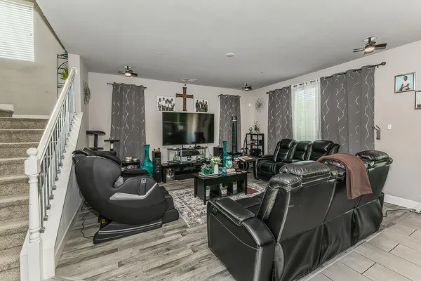 a dining room with stainless steel appliances kitchen island granite countertop a dining table chairs and a refrigerator