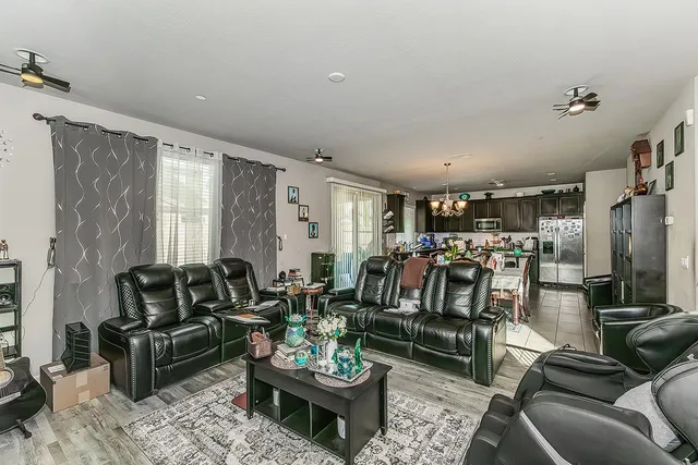 a living room with furniture and glass door