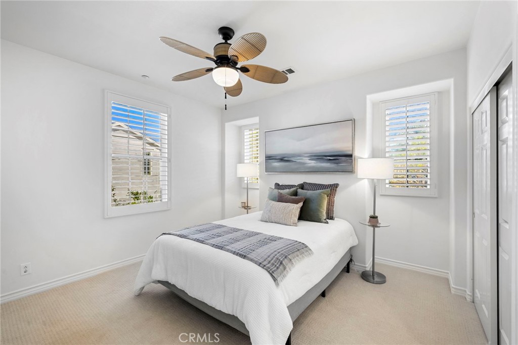 15 Mason Lane Ladera Ranch, CA 92694 - Photo 24 of 40 a bedroom with a large bed and a chandelier