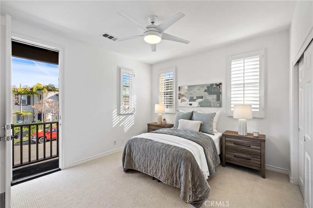 15 Mason Lane Ladera Ranch, CA 92694 - Photo 26 of 40 a bedroom with a bed a dresser and a chandelier