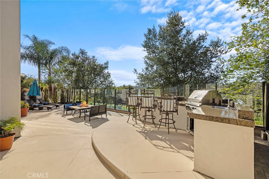 15 Mason Lane Ladera Ranch, CA 92694 - Photo 28 of 40 a view of a patio with a dining table and chairs with wooden fence