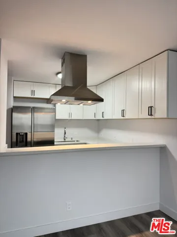 a kitchen with stainless steel appliances a sink and cabinets