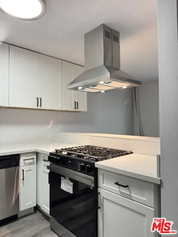 a stove top oven sitting inside of a kitchen