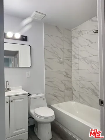 a bathroom with a toilet a sink and bathtub