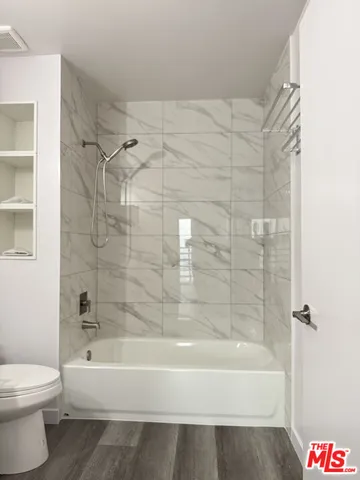 a bathroom with a bathtub and a toilet